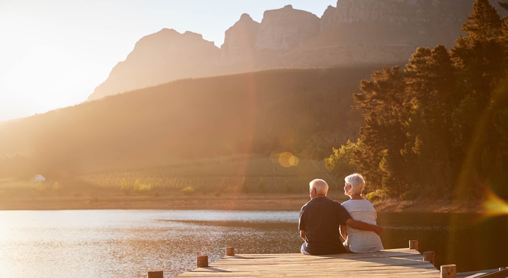 Relaxing couple sitting at a lake